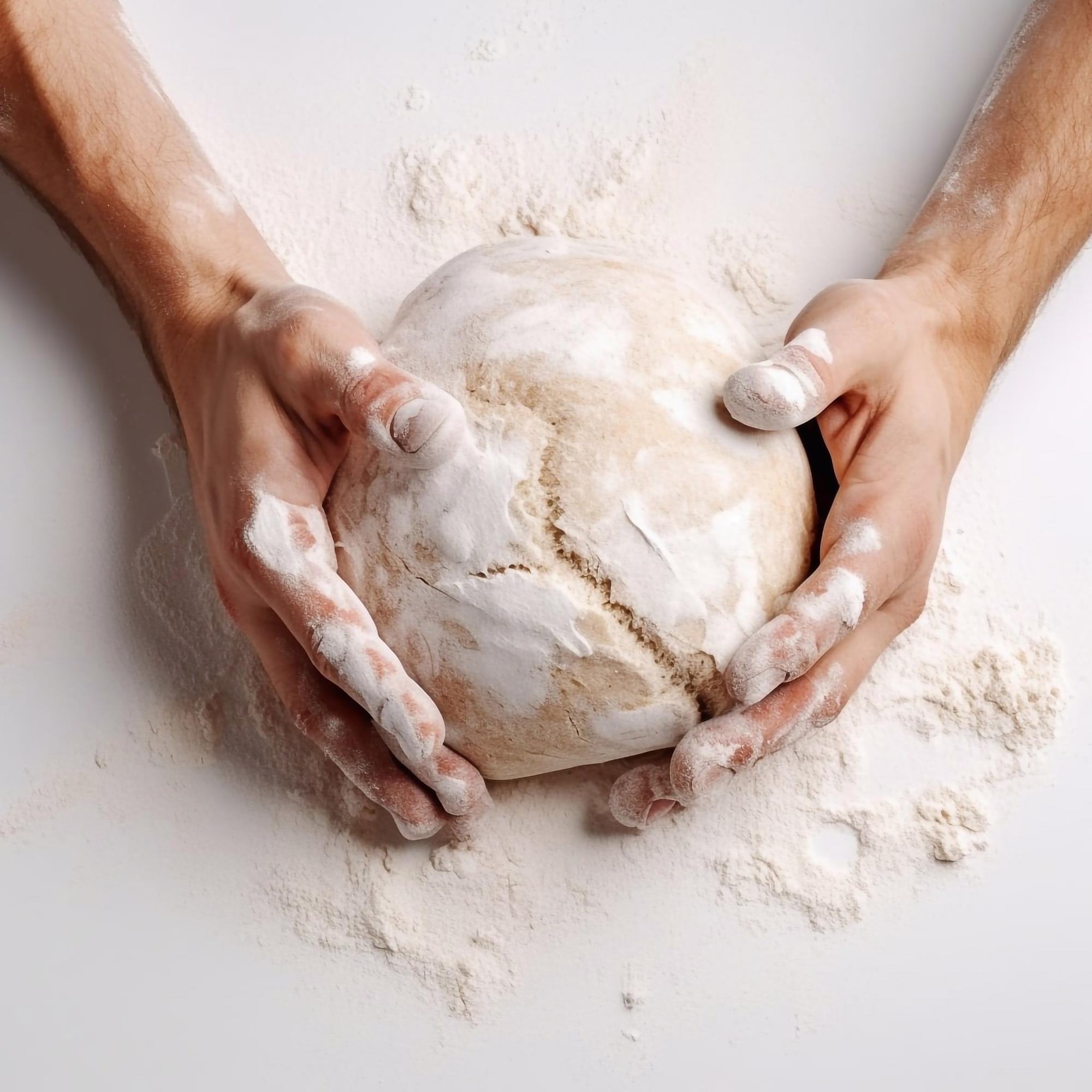 Hands shaping dough in natural light